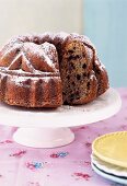 Blueberry bundt cake with sugar icing on cakestand