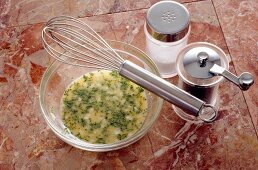 Bowl of spices and herbs vinaigrette with salt and pepper in shakers, step 3