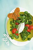 Corn salad with tomatoes, chervil cream cheese and butterfly shaped bread in bowl