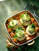 Stuffed kohlrabi with carrots, pistachios and veal meat in cooking pan
