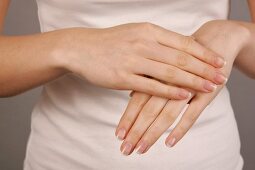 Close-up of woman applying lotion on her palms