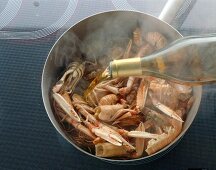 Deglazing sea food in pan with cognac