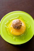 Baked chocolate croquettes with frozen passion fruit and whiskey on plate