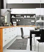 White kitchen-dining room with black accents