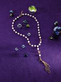 Gold and pearl chain on purple background