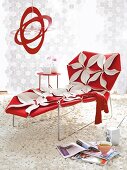 Red and white sun lounger with flowers on carpet