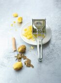 Potatoes with grater on plate