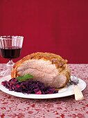 Shoulder of pork with red cabbage on plate