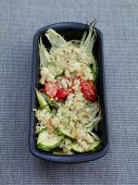 Spring vegetables with wild garlic crumble, tomatoes and zucchini in serving bowl