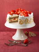 Strawberry cake with flaked almonds on a cake stand