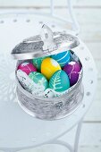 Close-up of colourful Easter eggs in silver box