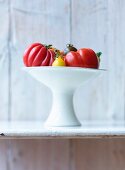 Various tomatoes in a white bowl