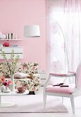 Room with floral pattern sofa, pink armchair and white floor lamp