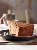 Piece of pecan cake with fork on plate
