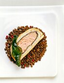 Close-up of lentil with salmon pate and seaweed leaves on plate