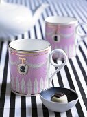 Pink coffee mug with playful medallion