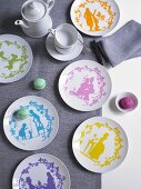 White plates with colourful paper cut designs