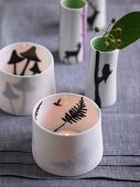 Porcelain tealight holders decorated with silhouettes