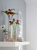 Blumen in Gläsern und Vase 