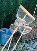 Fishing basket, bucket and fishing nets against pier