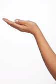 Close-up of hand indicating height sign against white background