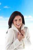 Portrait of attractive woman with long brown hair wearing cardigan, smiling