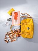 Two bags with sandals, towels and bracelets in white and yellow on white background