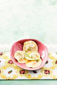 Dumplings stuffed with minced meat and parsley in pink ceramic bowl