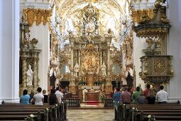 People in Rococo style chapel in Regensburg, Bavaria, Germany