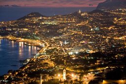 Aerial view of illuminated Funchal harbour and city at dusk, Madeira, Portugal