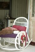 White rocking chair with several blankets