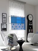 Two black and white chairs in front of blue and white window panels in living room