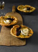 Goat cheese tarts on wooden serving plate
