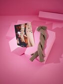 Knitted gloves with photo on pink background