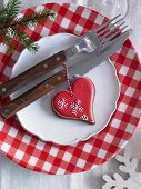 Red-white plate with heart shaped gingerbread and cutlery