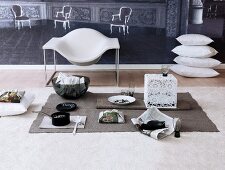 Stack of cushion, chair and bowl on carpet