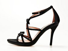 Close-up of black satin stilettos with small loop on white background