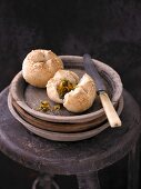 Rye bread rolls with a vegetable filling on a stack of wooden plates