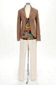 Blazer, spaghetti strap top and cotton trousers on white background