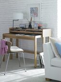 Office desk with bare oak worktop, lamp post and chair by side