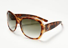 Close-up of leopard pattern sunglasses on white background