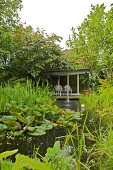 View of water lily pond, fountain and garden house