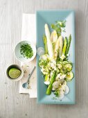Asparagus salad with feta cheese and herb on serving tray