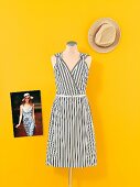 Black and white dress on mannequin and hat with catwalk photo