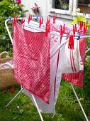 Drying rack with towels and tea towels in garden