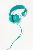 Turquoise headphones on white background