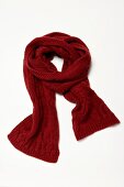 Red chunky knit scarf on white background