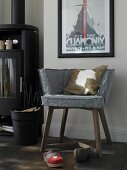 Chair with grey slipcovers and fur pillows with clogs