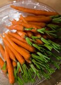 Close-up of several carrots on glass plate