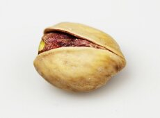 Pistachio in broken shell on white background